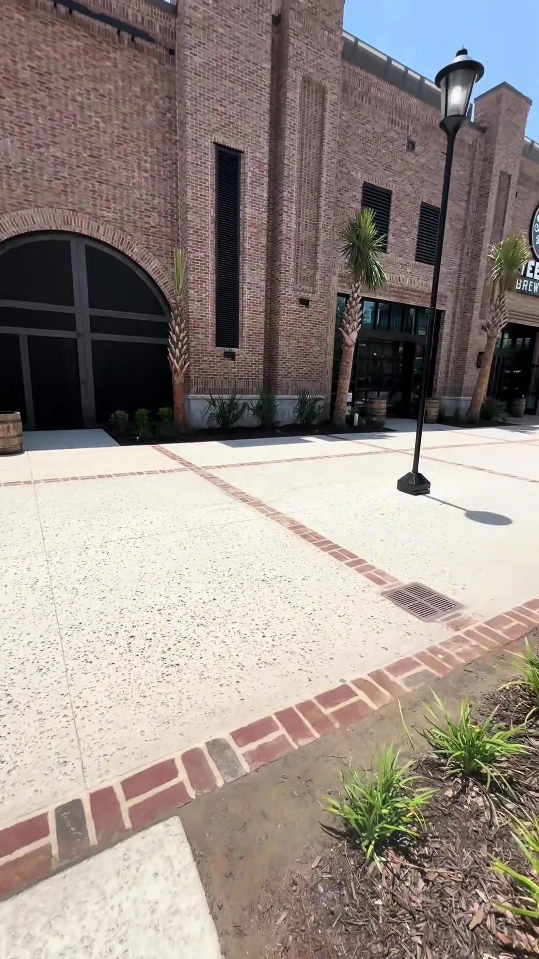 Stamped and scored decorative concrete plaza with brick banding