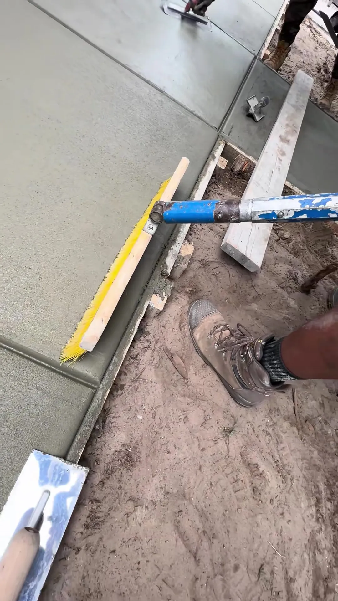 Trowel pass smoothing and resurfacing the face of a concrete slab