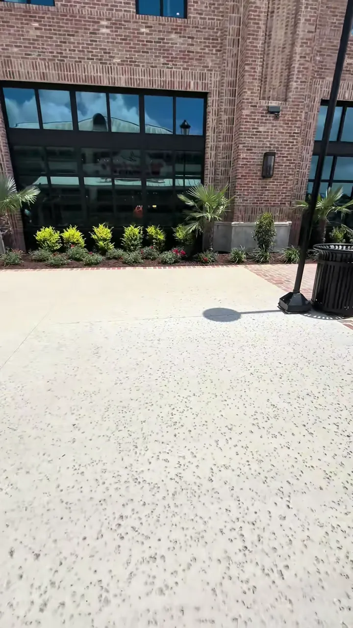 Finished stamped and scored commercial plaza with brick banding